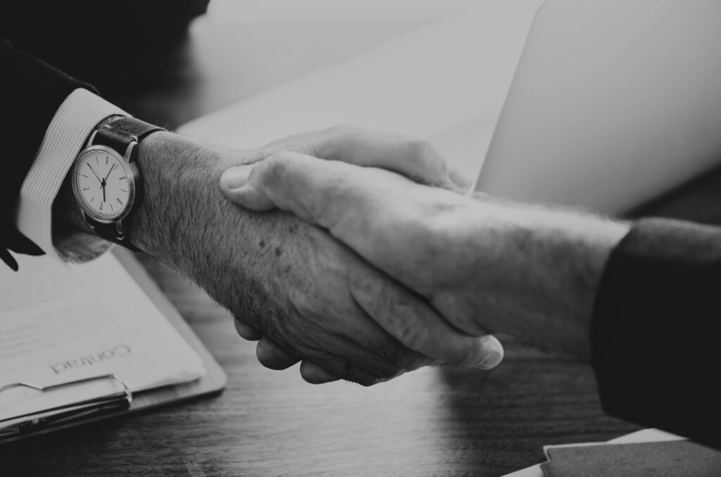 business people shaking hands together